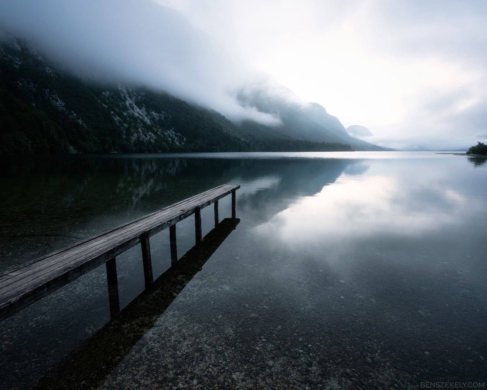 Nature photo of a dock located at the shore of a silent lake.