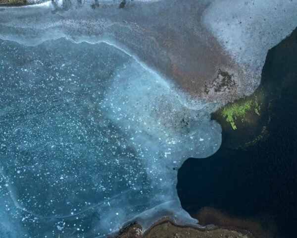 A half-frozen lake photographed with a drone