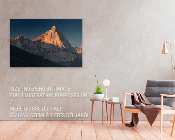 A fine art photography print of a mountain during a sunset hanging in a cozy home