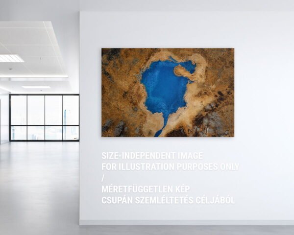 A wall art photo showing a blue lake surrounded by yellow land
