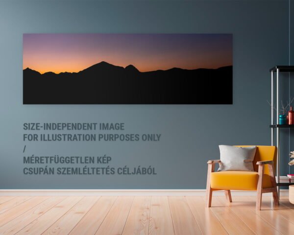 A panoramic nature photograph of a dark mountain range and an amazing sunset