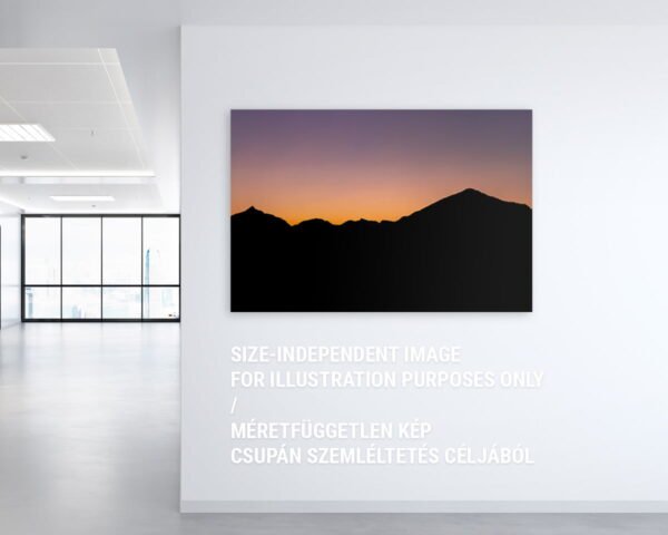 A wall art showing a silhouette of a mountain range during a sunset