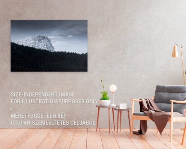 A fine art photograph of a grandiose snowy mountain hanging at a cozy scandinavian home