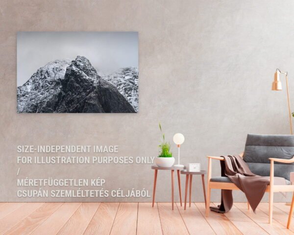 A fine art photography print of a snowy mountain top hanging at a home