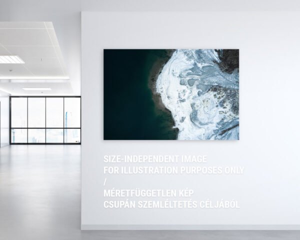 A fine art photography print of a glacier and a lake hanging on an office wall