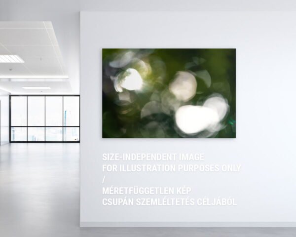 A mockup of a wall art image in an office. The art print is showing a nonfigurative pattern of forest lights.