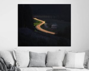 Long-exposure photograph of a curvy road with an illuminated car on it