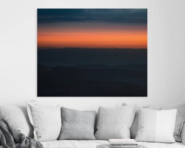 Wall art of a sunset above a mountain
