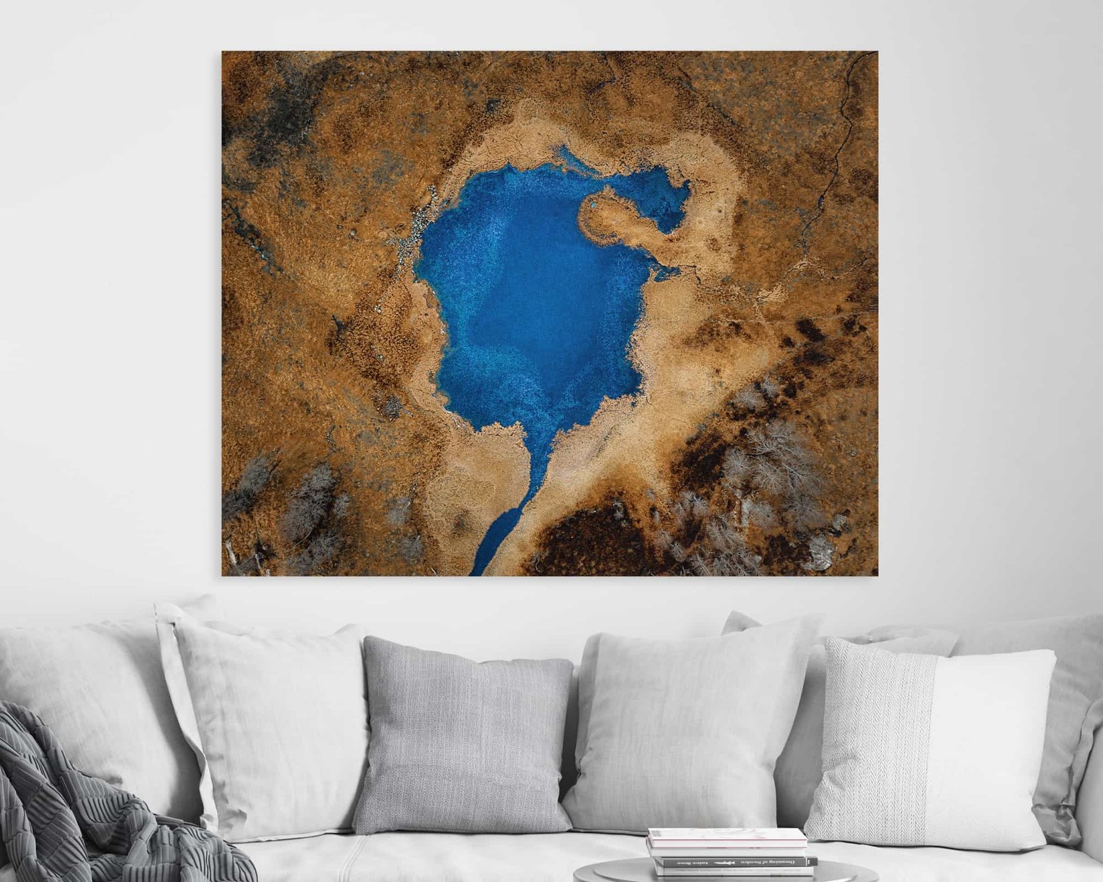Aerial photograph of a blue lake in front of a yellow land available as wall art