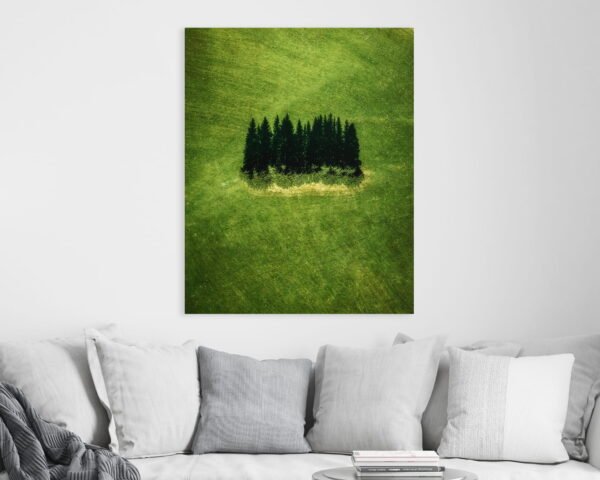 Vertical wall art of a group of green trees in the middle of a green field